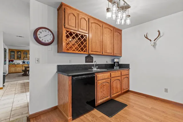 a kitchen with stainless steel appliances granite countertop a stove a sink and a chandelier