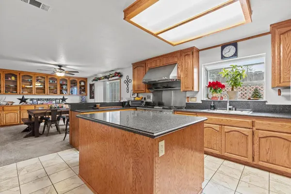 a kitchen with stainless steel appliances granite countertop a stove a sink and a refrigerator
