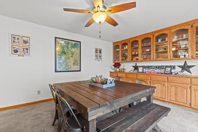 a dining room with a table and chairs