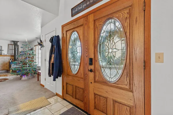 a bathroom with a toilet a sink and wooden floor