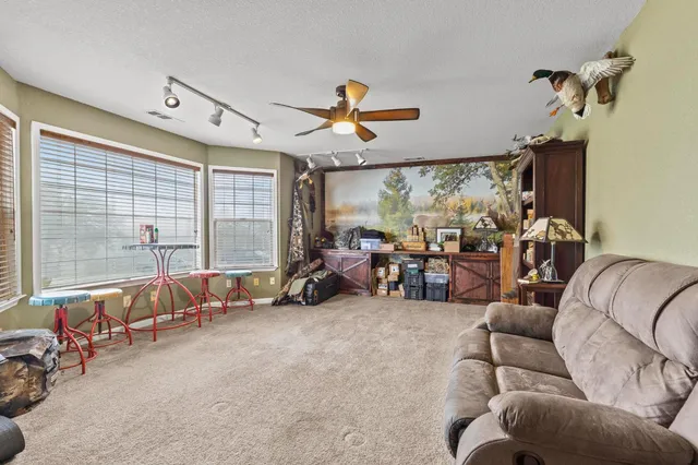 a view of staircase and living room with kitchen view