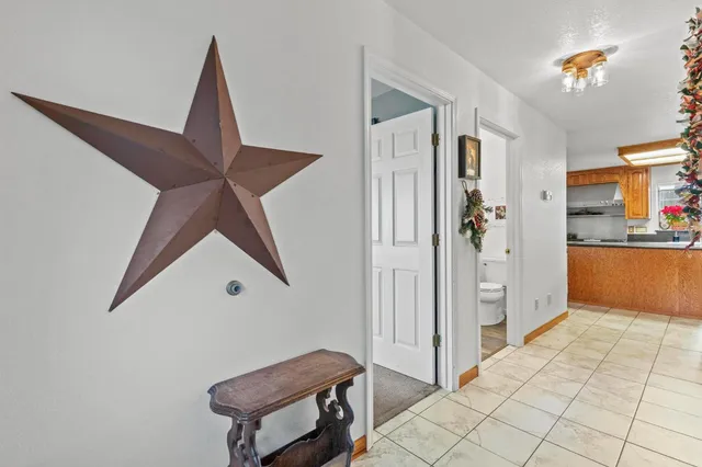 a bathroom with a toilet a sink and wooden floor