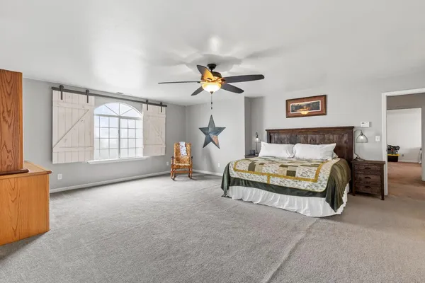 a bedroom with two beds and a chandelier