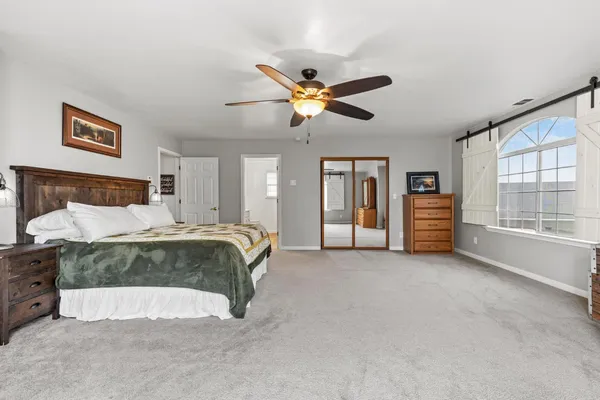 a bedroom with bed and window