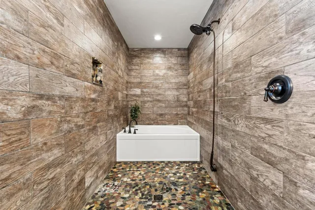 a bedroom with two beds and ceiling fan