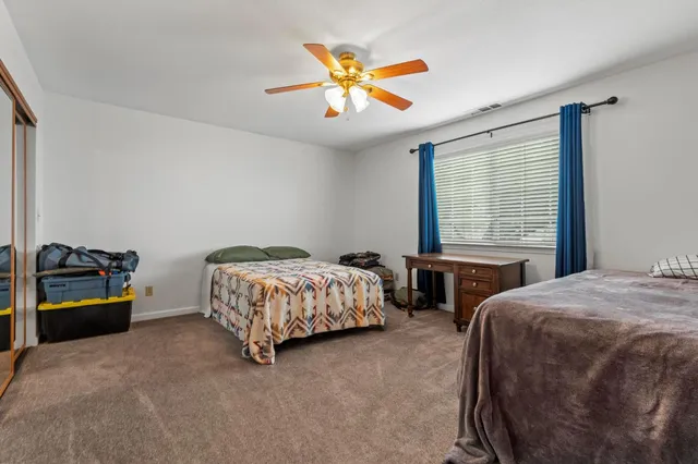 a bedroom with two beds and a chandelier