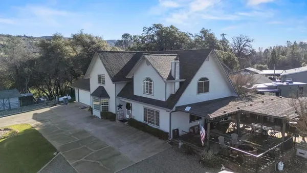 an aerial view of a residential houses with outdoor space