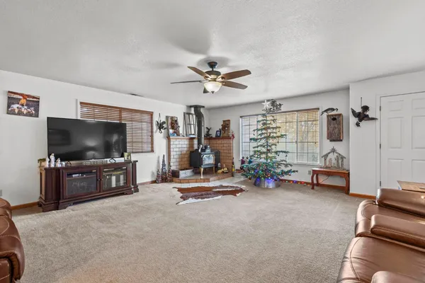 a living room with furniture a flat screen tv and a chandelier