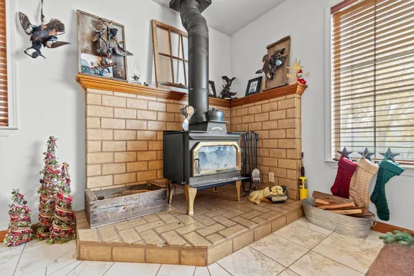 a kitchen with stainless steel appliances granite countertop a stove a sink and a chandelier