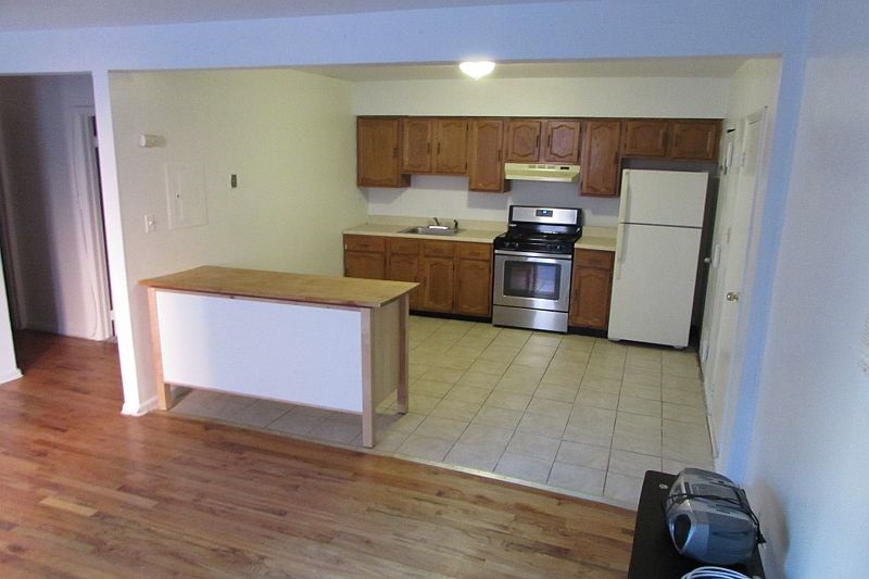 a kitchen with a sink a stove and a refrigerator