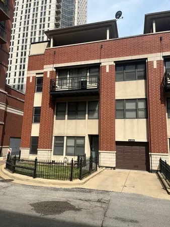 a front view of a building with a garden