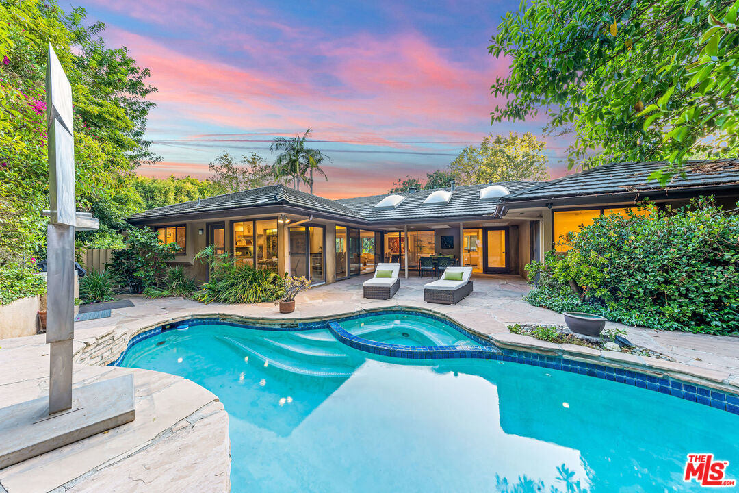 10871 Chalon Road Los Angeles, CA 90077 - Photo 2 of 41 a front view of a house with swimming pool having outdoor seating