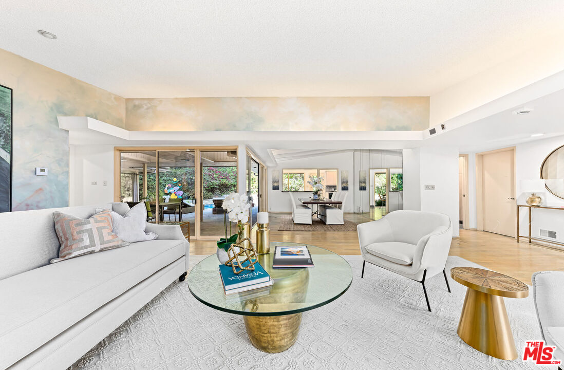 10871 Chalon Road Los Angeles, CA 90077 - Photo 13 of 41 a living room with furniture and a floor to ceiling window