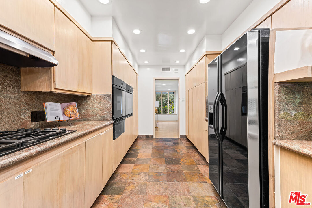 10871 Chalon Road Los Angeles, CA 90077 - Photo 20 of 41 a large kitchen with stainless steel appliances a refrigerator and a stove