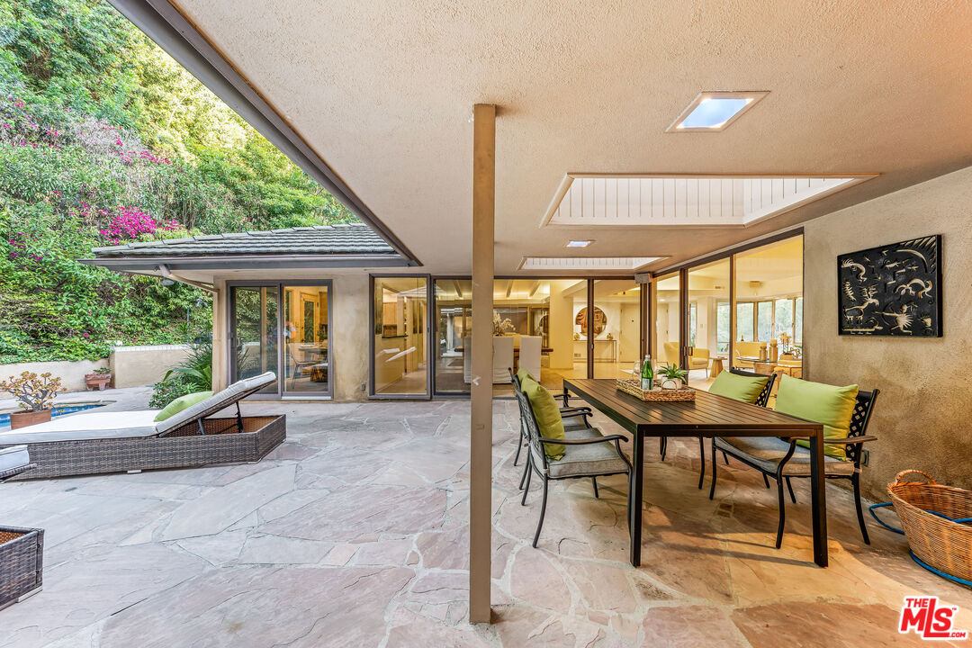 10871 Chalon Road Los Angeles, CA 90077 - Photo 26 of 41 a view of a patio with a table chairs and backyard