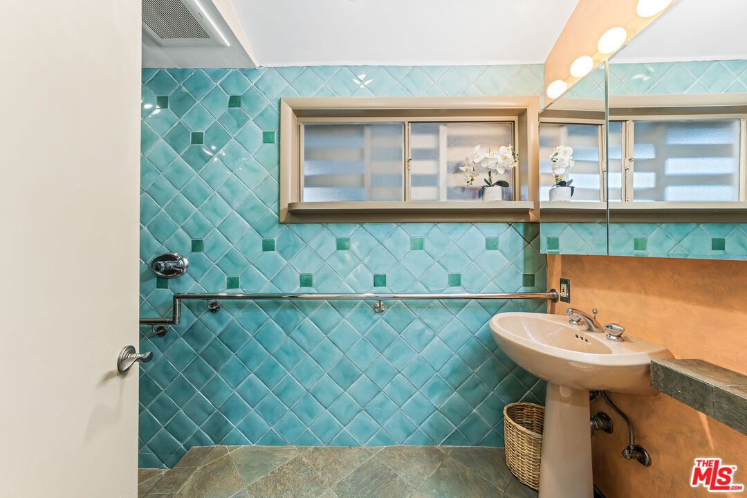 10871 Chalon Road Los Angeles, CA 90077 - Photo 28 of 41 a bathroom with a sink and a mirror