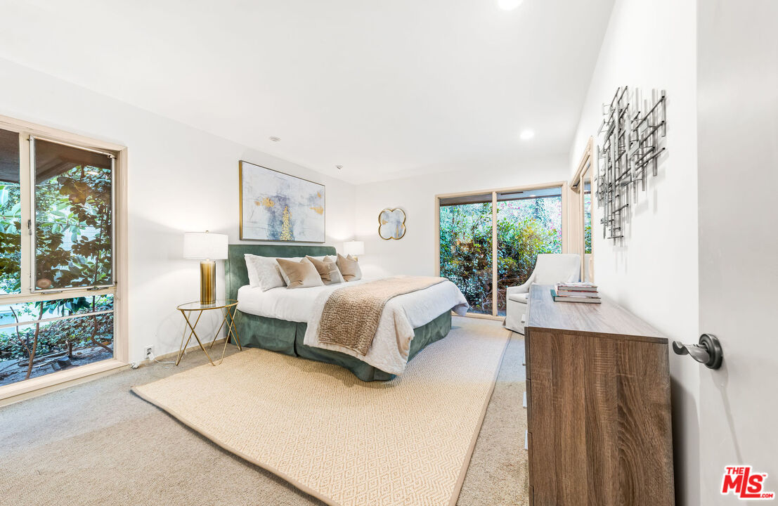 10871 Chalon Road Los Angeles, CA 90077 - Photo 33 of 41 a bedroom with a large bed and a window