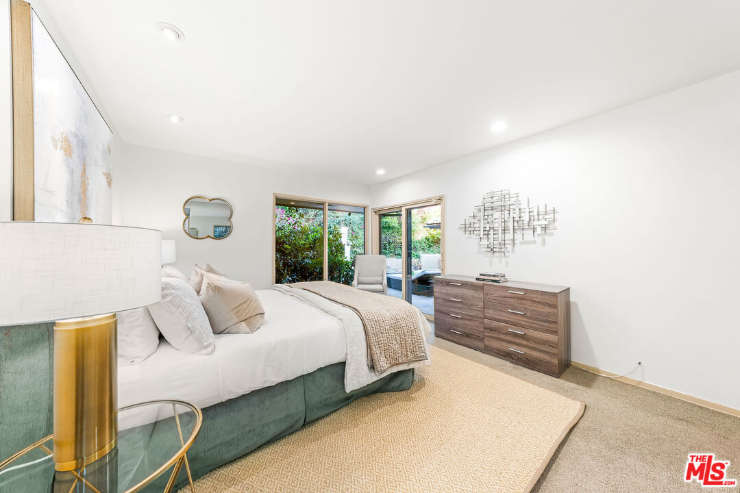 10871 Chalon Road Los Angeles, CA 90077 - Photo 36 of 41 a bedroom with a bed and large windows