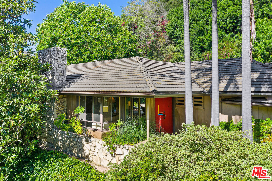10871 Chalon Road Los Angeles, CA 90077 - Photo 6 of 41 front view of a house with a garden