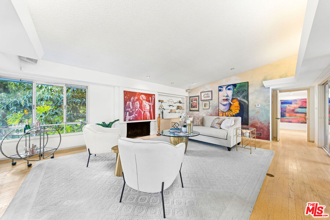 10871 Chalon Road Los Angeles, CA 90077 - Photo 10 of 41 a living room with furniture and a flat screen tv