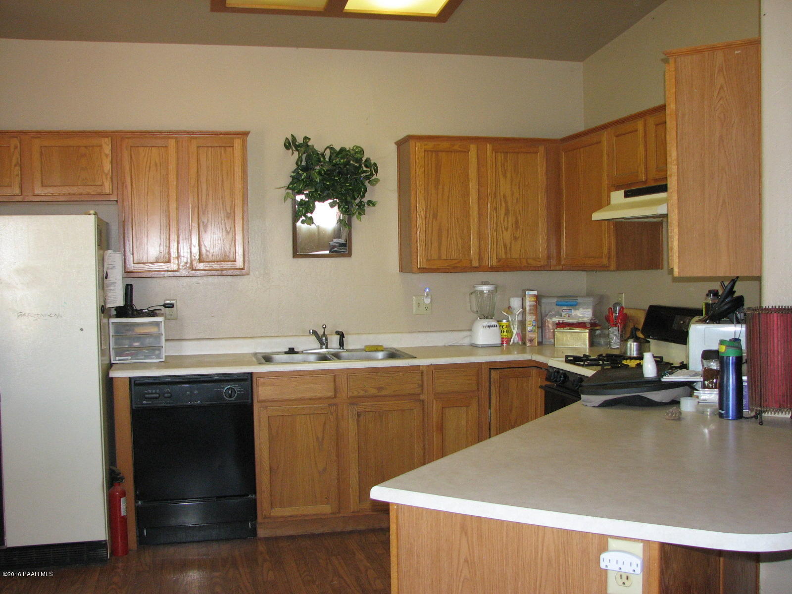 543 West Ahonen Road Paulden, AZ 86334 - Photo 4 of 24 a kitchen with a sink a stove and cabinets
