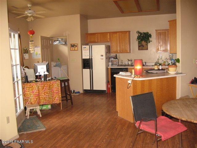 543 West Ahonen Road Paulden, AZ 86334 - Photo 5 of 24 a kitchen with stainless steel appliances wooden floor and chair