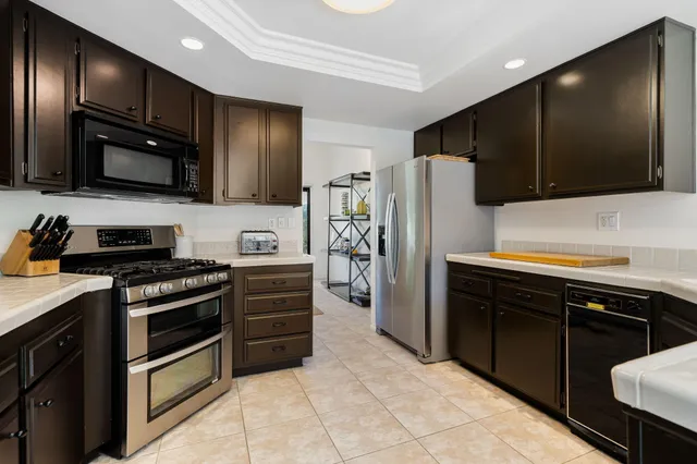 a kitchen with stainless steel appliances granite countertop a sink and cabinets