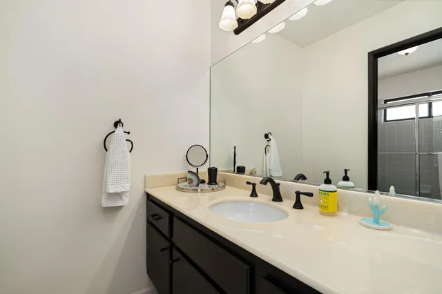 a view of a patio with furniture and a garden