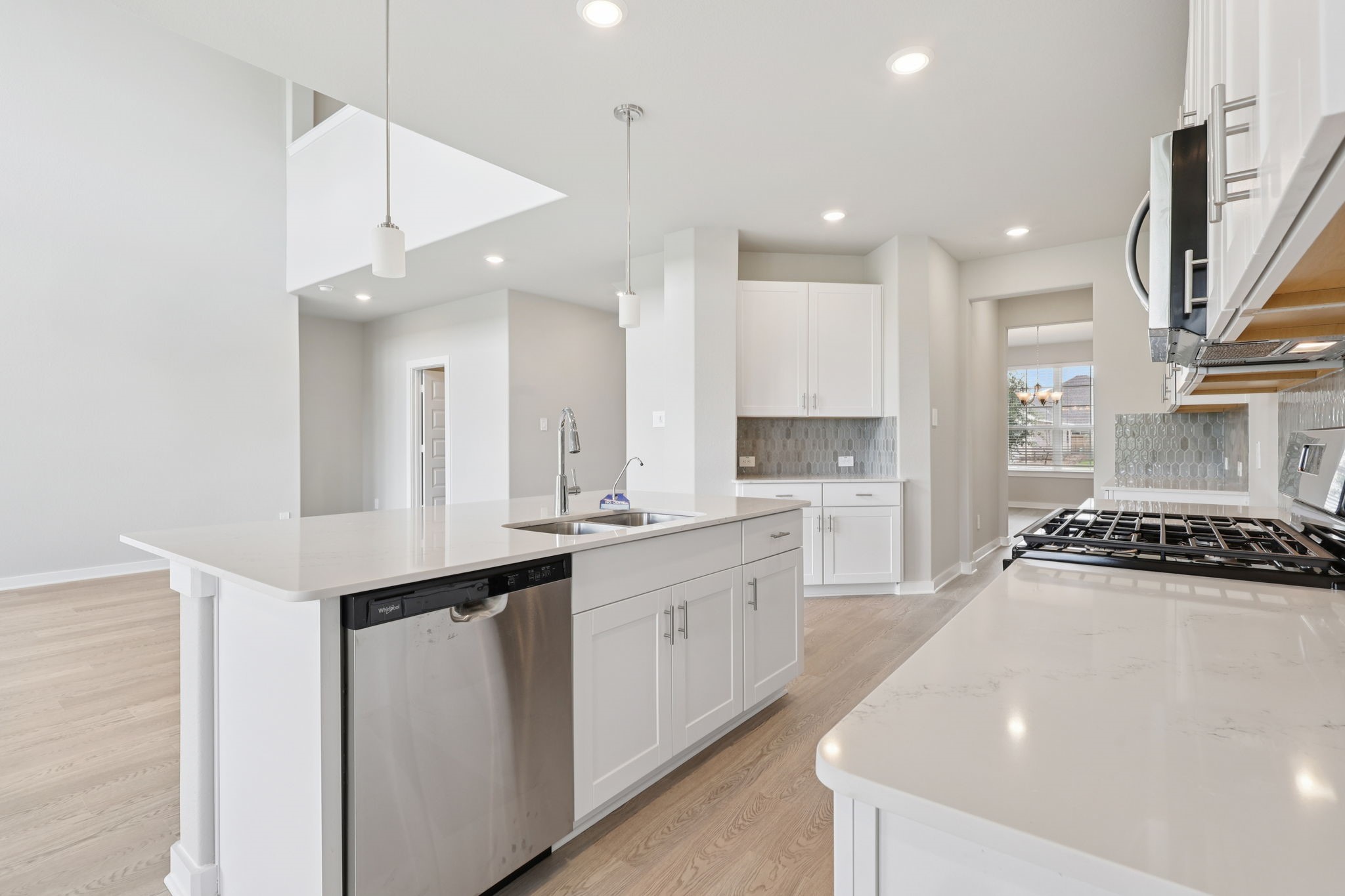 5710 Chamberlain Crossing Rosenberg, TX 77471 - Photo 12 of 40 a kitchen with stainless steel appliances granite countertop a sink a stove and a refrigerator