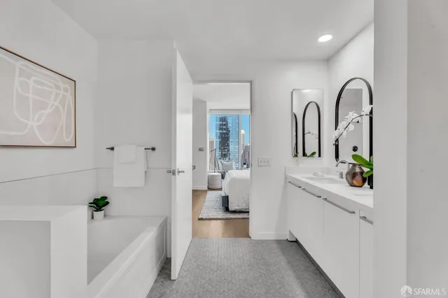 a bathroom with a double vanity sink and a two mirror