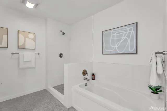 a bedroom with a bed a mirror and lamp