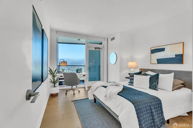 a balcony with furniture and a potted plant