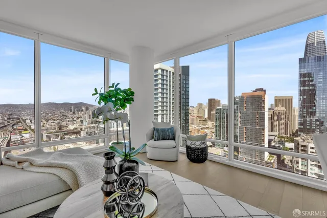 a living room with furniture and a floor to ceiling window