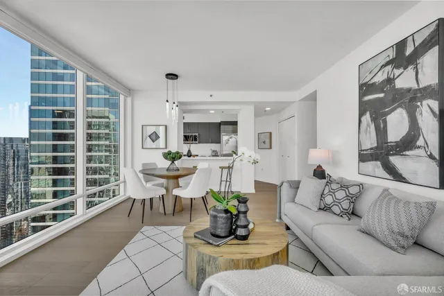 a large white kitchen with a large window and sink