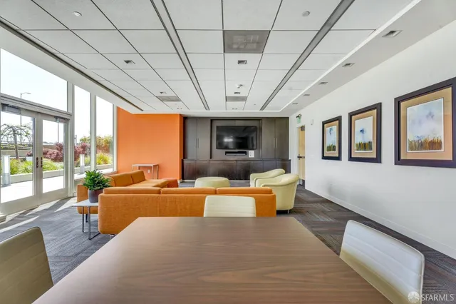 a dining room with furniture a rug and a large window