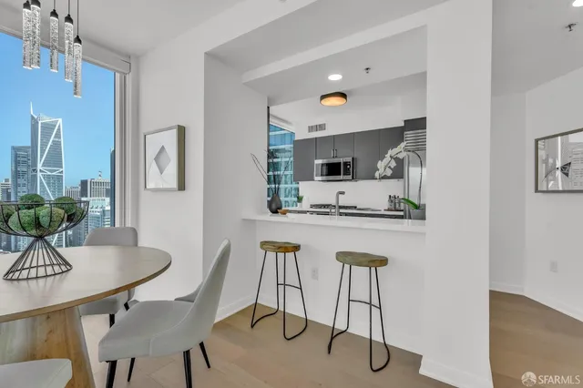 a kitchen with stainless steel appliances kitchen island dining table and chairs