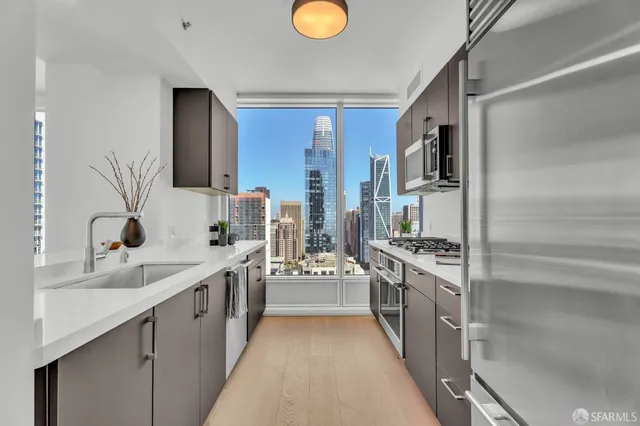 a kitchen with stainless steel appliances granite countertop a lot of counter space and wooden floors