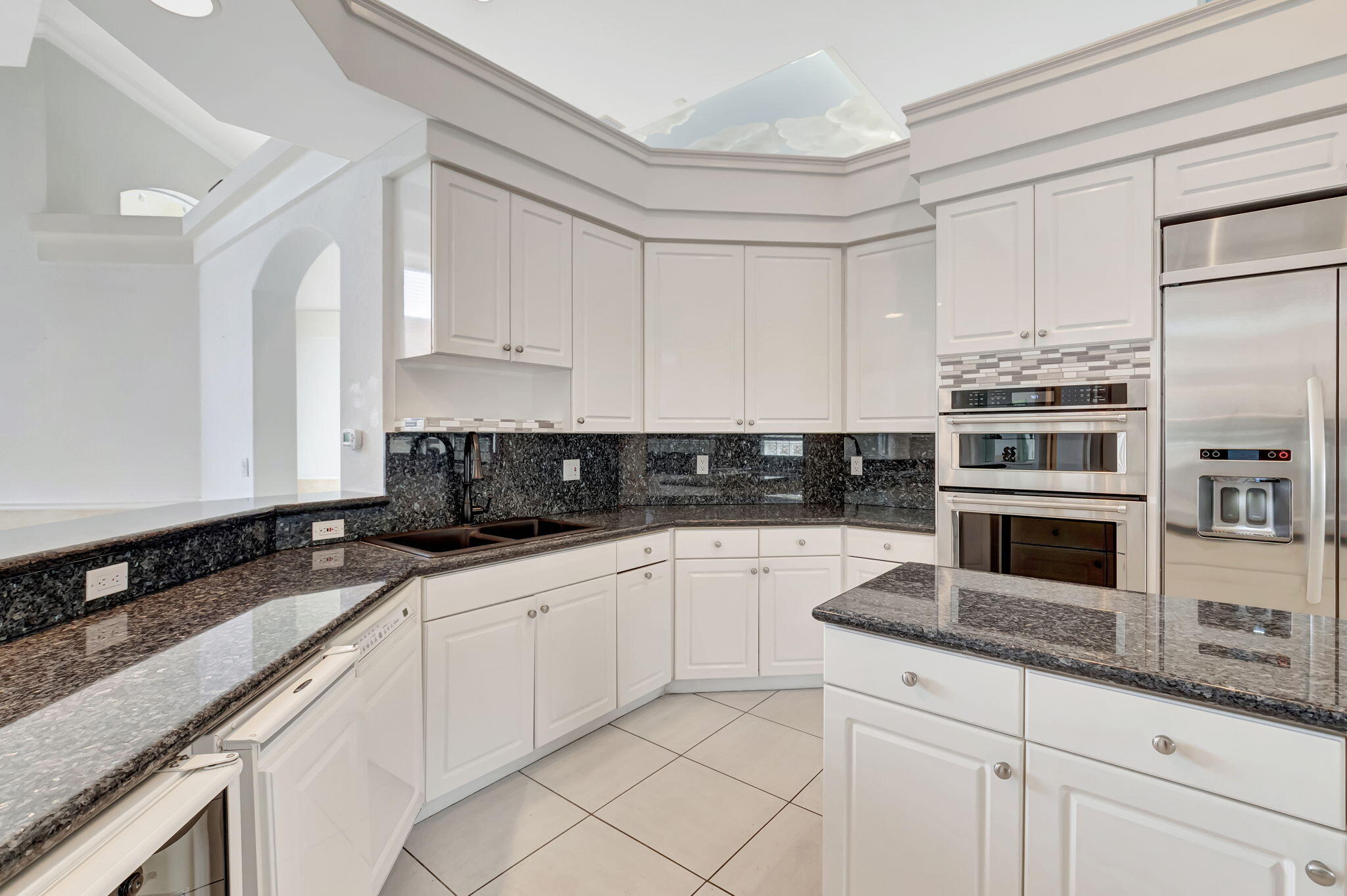 9152 Long Lake Palm Drive Boca Raton, FL 33496 - Photo 12 of 36 a kitchen with granite countertop a sink a stove and cabinets