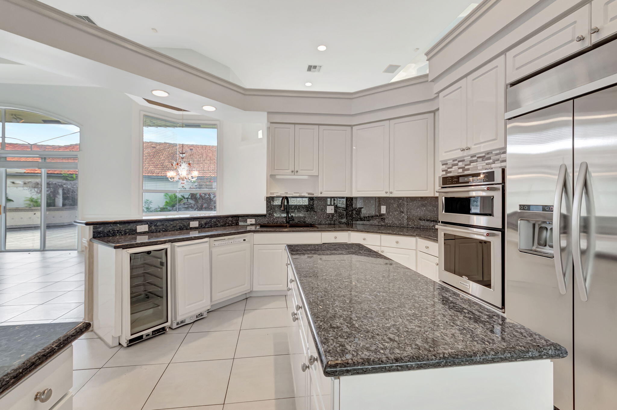 9152 Long Lake Palm Drive Boca Raton, FL 33496 - Photo 14 of 36 a kitchen with stainless steel appliances granite countertop a stove a sink and a refrigerator