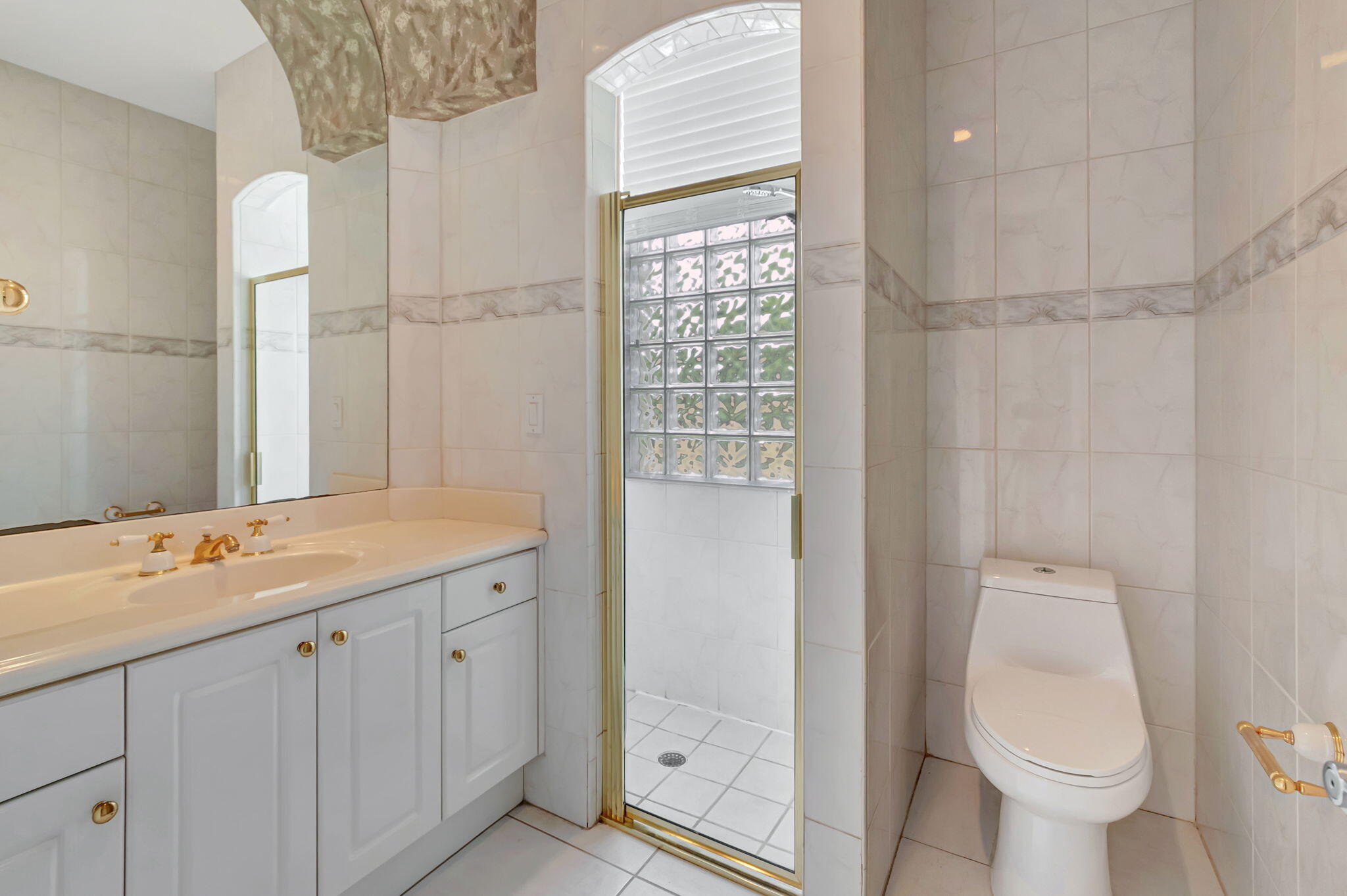 9152 Long Lake Palm Drive Boca Raton, FL 33496 - Photo 22 of 36 a bathroom with a granite countertop sink toilet and shower