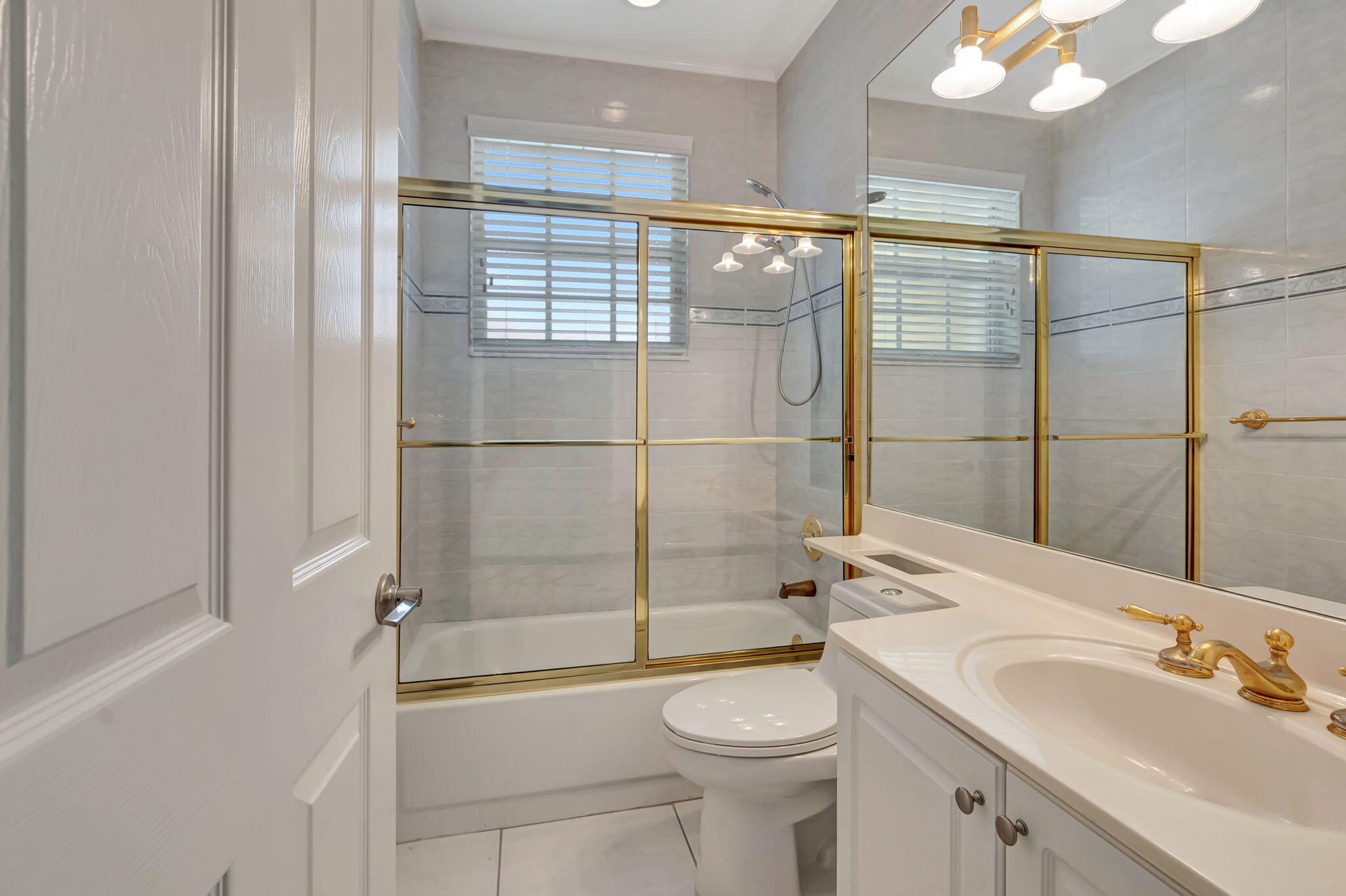 9152 Long Lake Palm Drive Boca Raton, FL 33496 - Photo 24 of 36 a bathroom with a shower a sink and toilet