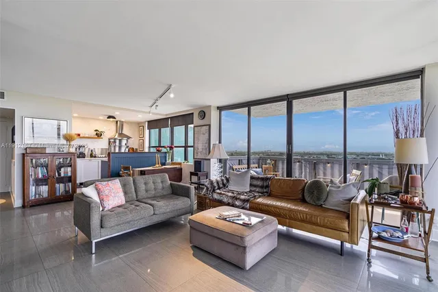 a living room with furniture and a large window