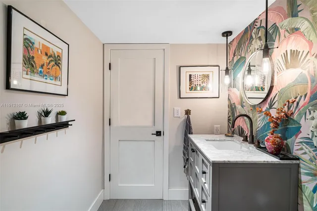 a bathroom with a granite countertop sink and a mirror
