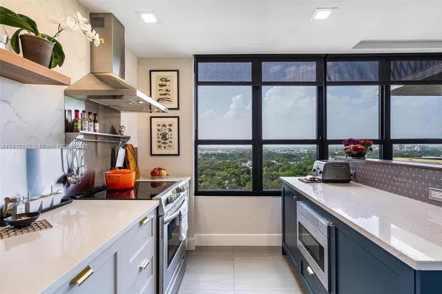 a kitchen with stainless steel appliances granite countertop a sink and a stove