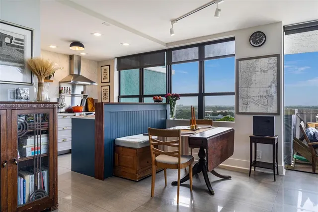a view of a workspace with furniture and a window