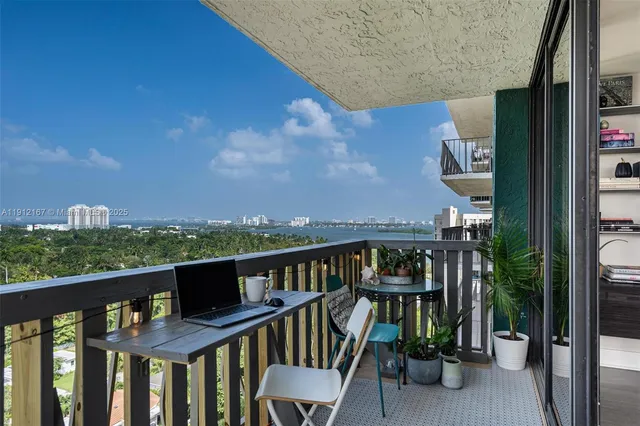 a view of a balcony with chairs and a table