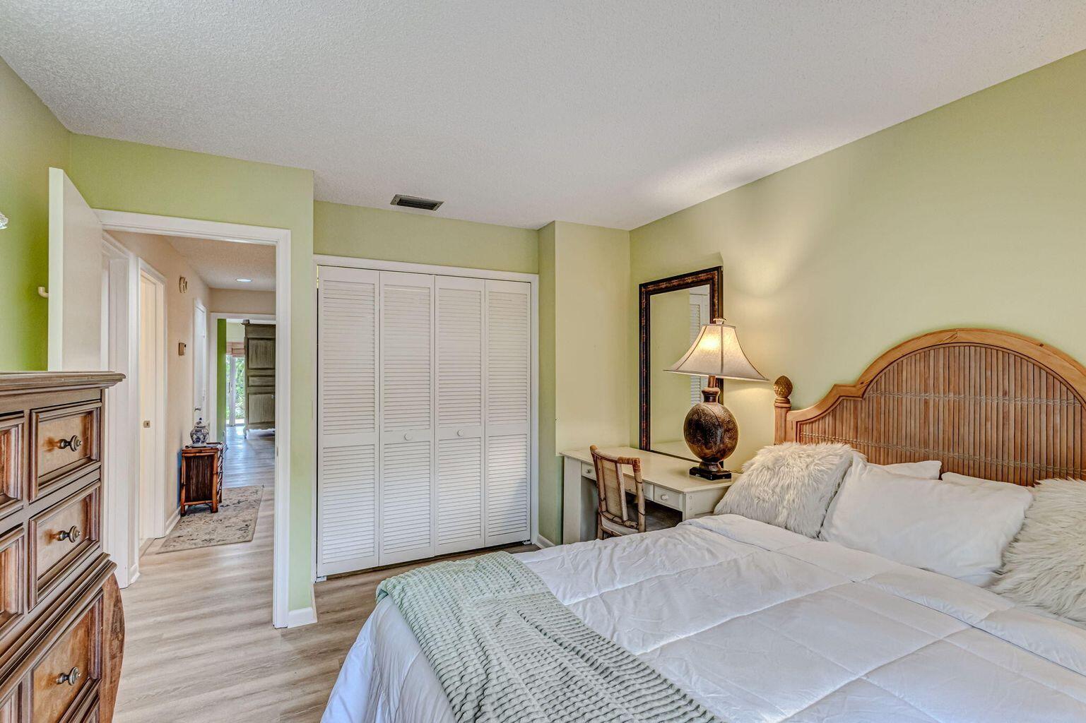 3667 Cape Pointe Circle Jupiter, FL 33477 - Photo 24 of 37 a bedroom with a bed and a mirror