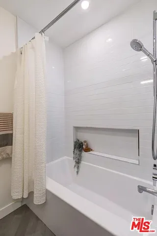 a bathroom with a bathtub and a shower