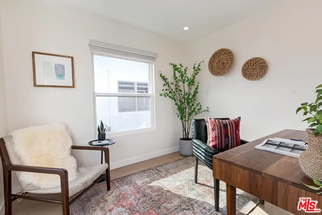 a view of a livingroom with furniture and a window