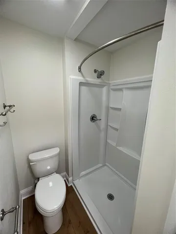 a bathroom with a shower and toilet